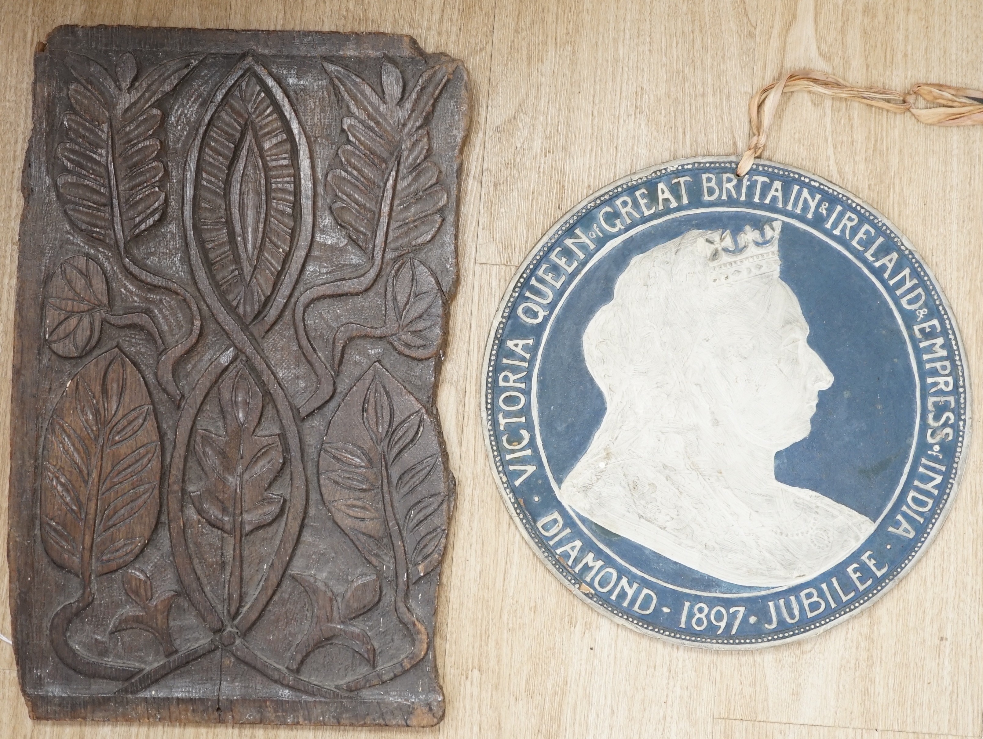 An 18th century carved oak panel together with a commemorative rounded ‘presented by the British and foreign school society to Florence Edith May, pupil in Stockwell College Practicing School to commemorate the completio